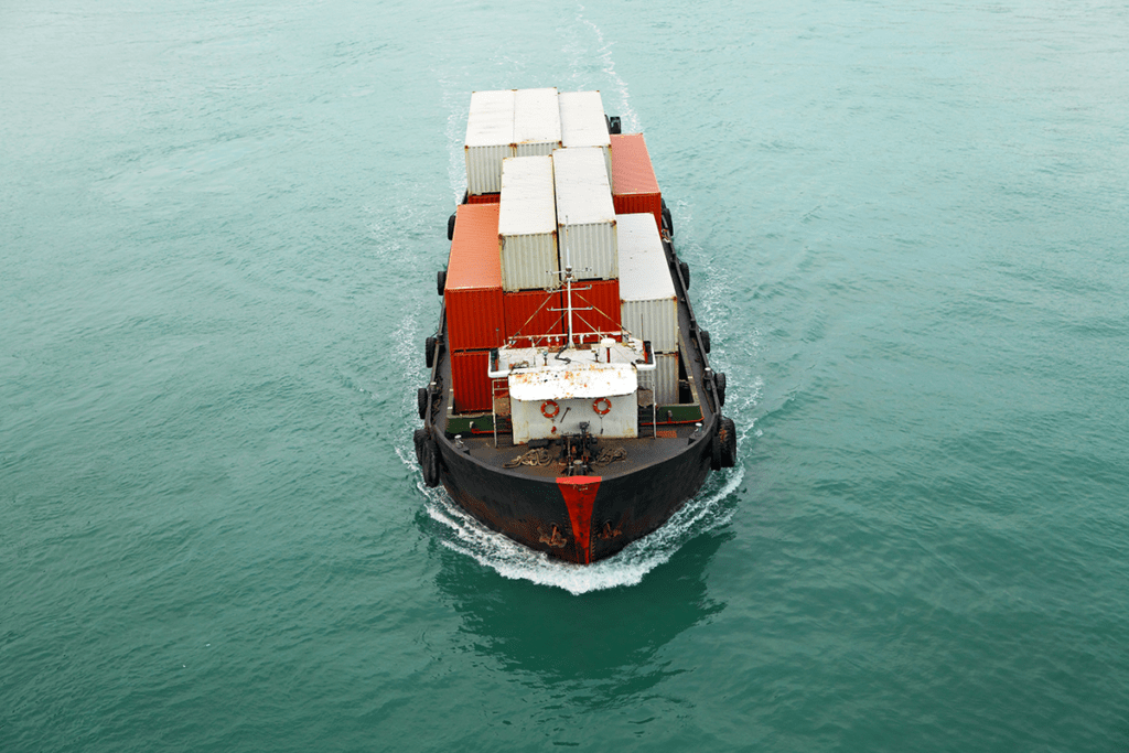 A photo of a ship full of containers as part of the global shipping industry.